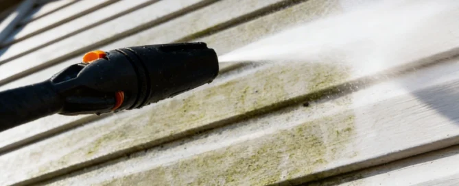 Pressure washing siding removes dirt and mold, revealing clean surface. Ideal for pressure washing Wilmington NC services.