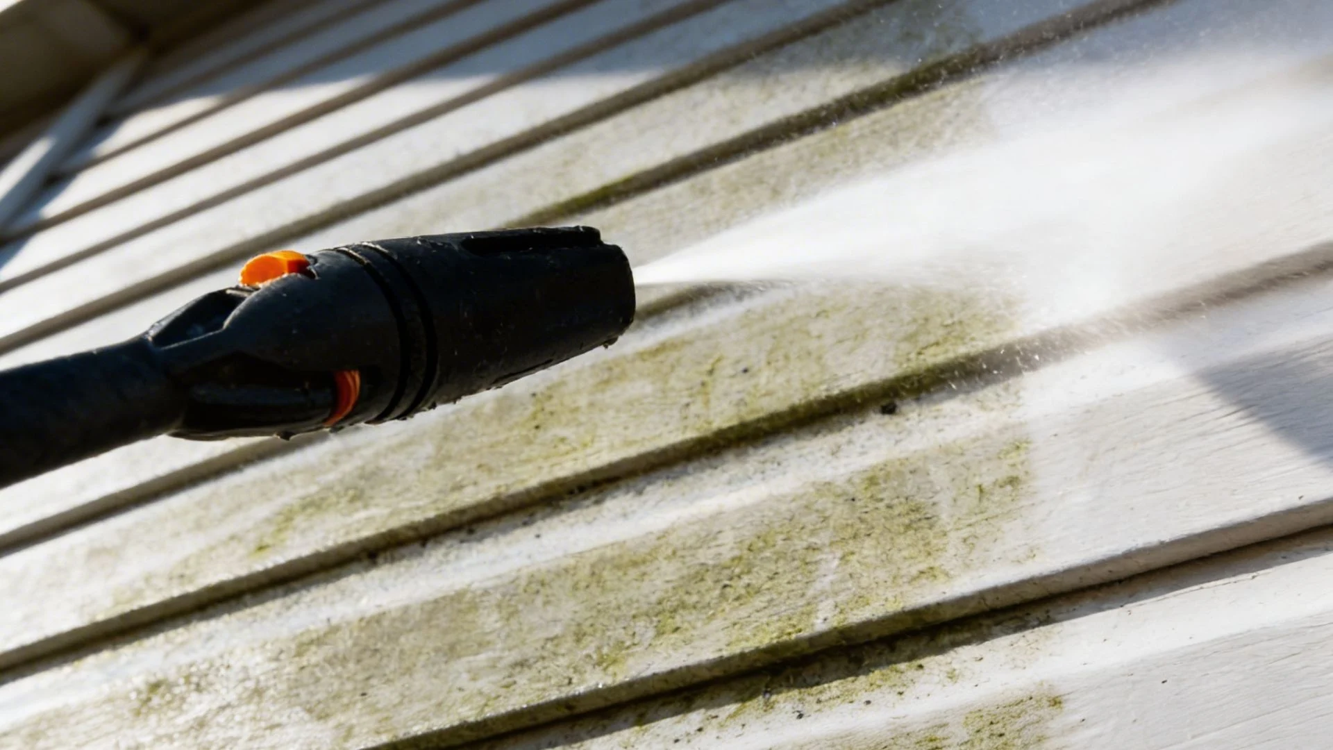 Pressure washing siding removes dirt and mold, revealing clean surface. Ideal for pressure washing Wilmington NC services.